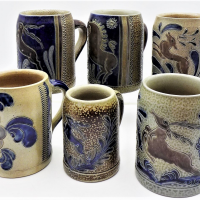 Group-lot-of-vintage-stoneware-salt-glazed-tankards-floral-deer-detail-some-signed-Sold-for-50-2021