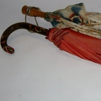 2 x 1930's ladies UMBRELLAS - printed cloth shade with wooden handle - red shade with carved Hand coloured wooden handle - both with cloth cover b - Sold for $49 - 2012