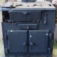 Lux cast iron stove with Jas McEwan Co Ltd badge, diamond pattern to top door and oven doors, some damage - Sold for $61 - 2013
