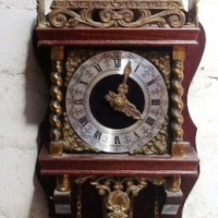 ATLAS WALL CLOCK with weights & pendulum, wooden case with ornate brass decorations, made in Holland - Sold for $110 - 2013