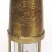 Reproduction BRASS MINERS LAMP, clear glass with raised CAMBRIAN oval badge to top section - Sold for $49 - 2013