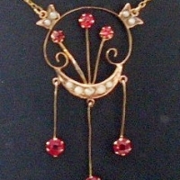 Edwardian 9ct gold Necklace - circular pendant suspended by chain featuring seed pearls,  three floral stems set with garnets and three garnet  - Sold for $232 - 2013