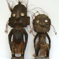 Pair of Papuan standing figures with & pierced noses cowrie shell eyes , feather hair etc - Sold for $61 - 2015