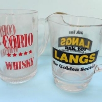 2 x Glass Whisky water advertising jugs with enamel advertising  - Langs Golden Scotch and Corio whisky - tallest 13cm - Sold for $37 - 2016