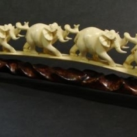 Carved vintage ivory  train of six elephants on wooden stand - 32cm long - Sold for $286 - 2016