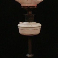 Vintage brass Aladdin table lamp - modified to electric with white and pink china shade raised lions head decoration - Sold for $56 - 2016