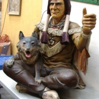 Large life size fibreglass figure of a seated Native American Indian Brave holding a wolf - full colour with applied decoration, approx - Sold for $261 - 2016