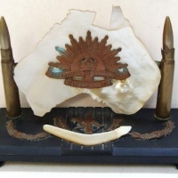 WW2 Trench Art Australian desk stand with rising sun hat badge and carved MOP Australia on hand carved slate base - Sold for $87 - 2016