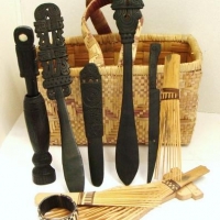 Woven basket of PNG Massim culture items incl combs, Lime spatulas & beetle nut mortar - Sold for $31 - 2016