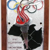 1956 Melbourne Olympic Games chrome & enamel plaque recasting mounted on wood - Sold for $43 - 2016