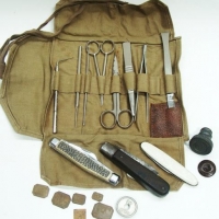 Small box - bloke's vintage items inc - 1950's travel first aid kit in roll up khaki green cloth, 3 x pocket knives, WW2  bottle bung, gold measuring  - Sold for $25 - 2016