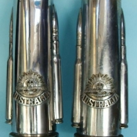 Lot 346 - Pair WW2 chromed trench art shell vases with bullets and Rising Sun cap badges - Sold for $106