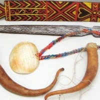 Lot 228 - Group lot Paupuan items inc - sheath, bailer shell necklace and palmwood sword - Sold for $37