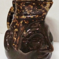 1930s Australian pottery Face jug by Sunshine Electrics and Bendigo Pottery - dark brown  with treacle mottles glaze - chip to back rim - Sold for $838 - 2017