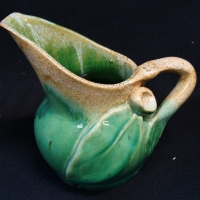1940's Remued Australian pottery jug with applied gum leaves and nut in green and cream glaze - shape 119 - approx 11cm tall - Sold for $161 - 2017