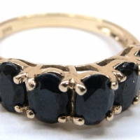 Ladies 9ct ygold Ring with 5 claw set near black sapphires - Sold for $248 - 2017