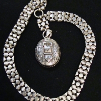 c1900 ornate oval Silver locket featuring a buckle on wide ornate linked chain - Sold for $261 - 2017