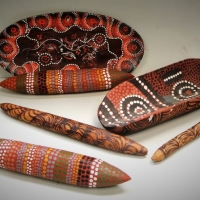 Group of Aboriginal items including miniature coolamon, clapping sticks with pyrography and dot painted designs - Sold for $37 - 2017