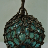 Vintage glass buoy with rope mesh holder - Sold for $186 - 2017