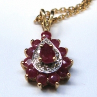 9Ct gold pear shaped pendant set with rubies & small diamonds on long chain marked 750 - Sold for $99 - 2017