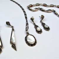 Group lot silver & marcasite jewellery incl Pair long mop earrings, oval moonstone pendant on twisted chain with matching earrings & bracelet with pea - Sold for $43 - 2017