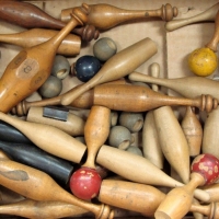 Group of turned wooden games pces incl numbered balls, skittles & tops - Sold for $62 - 2017