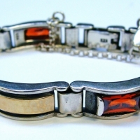 Modern ladies silver bracelet with oblong segments set with clear red stones - Sold for $37 - 2017