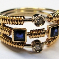 Unusual Ladies 18ct gold ring - with two dias & two dark blue sapphires set on three linked bands - TW52 grms - Sold for $397 - 2017