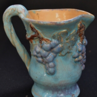 Australian pottery Jug with grape design by Una Deerbon signed to base 12 cm tall - Sold for $236 - 2017