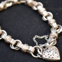 Heavy ornate silver charm bracelet with heart lock - Sold for $87 - 2017