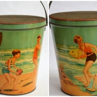 1930s Arnotts ' Bucket Series' Biscuit Tin - Sand bucket with lid featuring children playing on beach, adults, surfboard etc - 14oz nett, paper label  - Sold for $199 - 2018