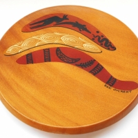 Eric Juckert turned Kauri pine wall plate with boomerang decorations - 15cm D - Sold for $25 - 2018