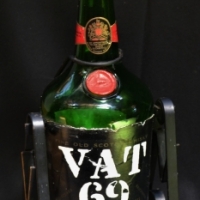 Vintage 'Vat 69' 2 quarts bottle in curly metal stand with pourer - Sold for $25 - 2018
