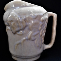 Large 1930s Florenz Australian pottery jug, creammauve glazed with embossed grape & vine - made for Ye Olde Crusty Wine Bar - marked to base - 19cms H - Sold for $25 - 2018