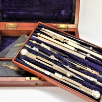 c1900 Technical drawing set in Mahogany case including Ebony parallel rule, nickel tools and ivory handled tools - Sold for $87 - 2018
