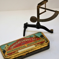 2 x Items cast iron & brass letter scale & Tin Draughtsman's set Mathematical Instruments with contents - Sold for $25 - 2018
