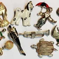 Group Lot Novelty Glitzy brooches inc - animals, trumpet, people, etc - Sold for $43 - 2018