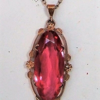 1920s 9ct rose gold pendant with large oval pink semi precious stone in floral mount on chain - Sold for $87 - 2018