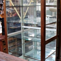 Large hardwood glass display case 185cm tall on castors with mirrored back 107cm wide 65cm deep - Sold for $472 - 2018