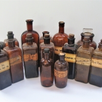 Shelf of Brown glass apocathery glass bottles - Sold for $50 - 2018