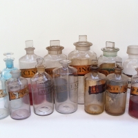 Shelf of large Apocathery bottles with Gilt labels and fitted stoppers - Sold for $373 - 2018