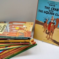 Large collection of comics by Herge - Tintin in French and English hard and soft covers - Sold for $137 - 2018