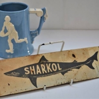 2 x Pieces - small metal SHARKOL Tin sign + Blue & White pottery Tankard featuring RUGBY - Sold for $27 - 2018