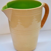 Large 1960s Australian pottery jug by Allan Lowe with cane wrapped handle 23cm tall - Sold for $47 - 2018