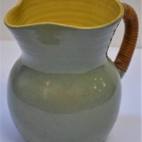 1950s Australian pottery Jug with cane wrapped handle By Allan Lowe in Blue and yellow glaze - Sold for $50 - 2018