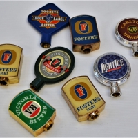 Group of vintage beer tap tops including Foster and Carlton Draught - Sold for $37 - 2018