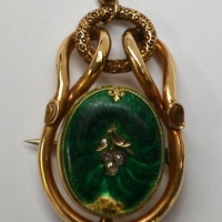 c1890 9ct Brooch - oval green enamel (af) with inlaid floral spray to centre set with tiny old cut diamonds - Sold for $62 - 2018