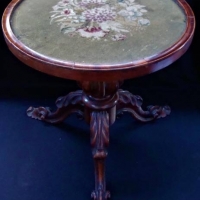 Carved three legged circular mahogany table with embroidery under glass top - Beautiful bulbous central pillar and scrolled feet - Sold for $149 - 2018