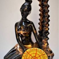 1950s black & yellow ceramic Garnier Liqueurs figural bottle featuring palm tree trunk , kneeling woman with basket - 31cms H - Sold for $37 - 2018
