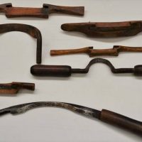 Group of antique spokeshaves and drawknives including Blacksmith made handle makers drawknife - Sold for $43 - 2018